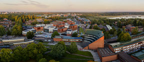 An aerial photo of the Aalto University campus at sunset.