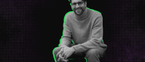 Man wearing a grey jumper and jeans crouching in front of a purple dotted background with neon green outline